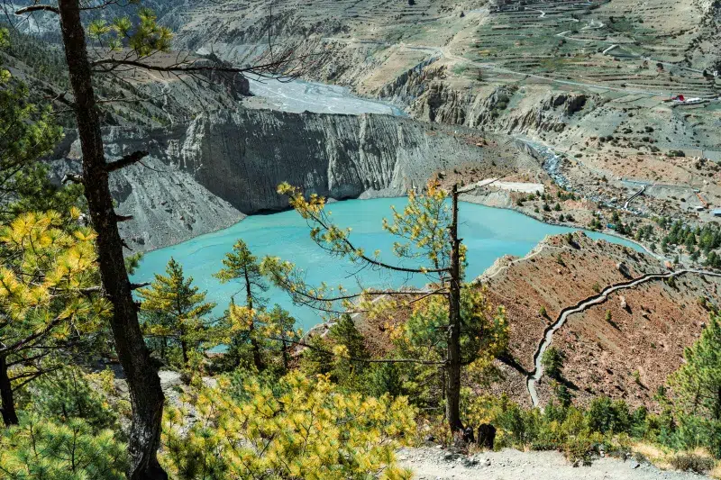 Vista panorámica de Gangapurna Lake con aguas turquesa en ruta de trekking en Annapurna.
